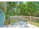 Cozy wooden back deck with a railing overlooking a spacious backyard with mature trees at 100 Davis Mill N Rd, Dallas, GA 30157