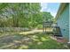 A partially fenced backyard with a deck, mature trees, and plenty of space at 100 Davis Mill N Rd, Dallas, GA 30157