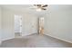 Spacious carpeted bedroom featuring a ceiling fan, closet, and multiple doorways at 100 Davis Mill N Rd, Dallas, GA 30157