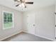 Bright bedroom featuring a window, ceiling fan, and neutral paint scheme at 100 Davis Mill N Rd, Dallas, GA 30157