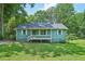 Charming, light green single-story home with a cozy front porch and well-manicured lawn at 100 Davis Mill N Rd, Dallas, GA 30157