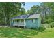 View of light green house featuring a cozy front porch and tidy, green lawn at 100 Davis Mill N Rd, Dallas, GA 30157