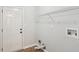 Functional laundry room with white door, overhead rack, and convenient utility connections at 100 Davis Mill N Rd, Dallas, GA 30157