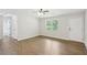 Hardwood floors gleam in this bright living room next to the tiled bath with a white door at 100 Davis Mill N Rd, Dallas, GA 30157