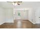 Open-concept living room with hardwood floors, fan, and a bright open floor plan at 100 Davis Mill N Rd, Dallas, GA 30157