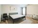 Neutral bedroom with a bed, office chair, modern art and ample floor space at 2496 Osceola Rd, Lithonia, GA 30058