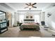 Spacious bedroom with tray ceilings, a large bed, and access to an ensuite bathroom at 2496 Osceola Rd, Lithonia, GA 30058