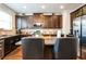 Beautiful kitchen featuring dark cabinetry, granite countertops, stainless steel appliances, and an island at 2496 Osceola Rd, Lithonia, GA 30058