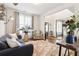 Well-lit living room showcasing stylish furnishings, hardwood floors, and large windows at 2496 Osceola Rd, Lithonia, GA 30058