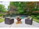 Inviting backyard pool area with comfortable seating and a fire pit, perfect for outdoor entertaining at 3117 W Roxboro Ne Rd, Atlanta, GA 30324