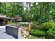 Expansive backyard view showcasing a deck, pool, stone pathway, and beautifully landscaped gardens at 3117 W Roxboro Ne Rd, Atlanta, GA 30324