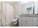 Clean bathroom featuring a shower with curtain, toilet and white vanity at 3117 W Roxboro Ne Rd, Atlanta, GA 30324