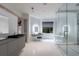 Sleek bathroom featuring gray vanities, modern fixtures, soaking tub and glass shower at 3117 W Roxboro Ne Rd, Atlanta, GA 30324