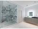 Contemporary bathroom with a glass enclosed marble shower and gray floating vanity at 3117 W Roxboro Ne Rd, Atlanta, GA 30324