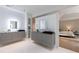 Bright bathroom with gray floating vanities and black sinks adjacent to bedroom at 3117 W Roxboro Ne Rd, Atlanta, GA 30324