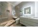 Bathroom featuring a glass shower, sleek floating vanity, and modern tile design at 3117 W Roxboro Ne Rd, Atlanta, GA 30324