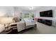 Cozy bedroom with neutral color palette, bay window, and a flat-screen TV at 3117 W Roxboro Ne Rd, Atlanta, GA 30324
