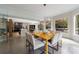 Dining room boasts a yellow table, modern light fixture, and large windows with green views at 3117 W Roxboro Ne Rd, Atlanta, GA 30324