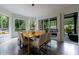 Dining room with unique lighting fixture and access to an outdoor patio with wooded view at 3117 W Roxboro Ne Rd, Atlanta, GA 30324