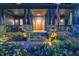 Inviting front porch featuring stone accents, blue pillars, stylish front door, and beautifully landscaped flower beds at 3117 W Roxboro Ne Rd, Atlanta, GA 30324
