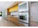 Modern kitchen with stainless steel appliances, wood cabinetry, and marble countertops at 3117 W Roxboro Ne Rd, Atlanta, GA 30324