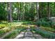 Lush landscaped garden featuring a stone pathway, creating a serene and inviting outdoor space at 3117 W Roxboro Ne Rd, Atlanta, GA 30324