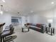 Open-concept living room with plush gray sectional and glass coffee table at 3117 W Roxboro Ne Rd, Atlanta, GA 30324