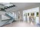 Bright living room featuring a floating staircase with glass railings and an open layout at 3117 W Roxboro Ne Rd, Atlanta, GA 30324