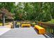 Relaxing deck area featuring vibrant yellow benches and lush greenery, creating a tranquil outdoor space at 3117 W Roxboro Ne Rd, Atlanta, GA 30324