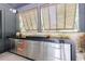 Modern outdoor kitchen featuring stainless steel cabinets, a sleek countertop, and a convenient sink at 3117 W Roxboro Ne Rd, Atlanta, GA 30324