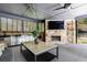 Outdoor kitchen featuring a stone fireplace and stainless steel cabinetry at 3117 W Roxboro Ne Rd, Atlanta, GA 30324