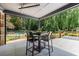Inviting covered outdoor patio with a dining table, and views of the lush green backyard and swimming pool at 3117 W Roxboro Ne Rd, Atlanta, GA 30324