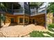 A stone patio with doors leading to the lower level of a two-story home and a covered outdoor seating area at 3117 W Roxboro Ne Rd, Atlanta, GA 30324
