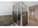 Walk-in shower with glass doors and neutral-colored tile at 3117 W Roxboro Ne Rd, Atlanta, GA 30324