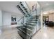Modern staircase with glass railings and wood treads, offering a view into other rooms at 3117 W Roxboro Ne Rd, Atlanta, GA 30324