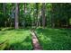 Charming stone pathway winding through a lush green garden, leading to a tranquil backyard setting at 3117 W Roxboro Ne Rd, Atlanta, GA 30324