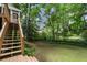 Spacious backyard with stairs to the wooden deck at 3214 Woodleaf Ct, Marietta, GA 30062