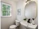 Stylish half bath with modern vanity, mirror, and fixtures, and bright natural light at 3214 Woodleaf Ct, Marietta, GA 30062