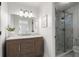 Modern bathroom with marble vanity, decorative mirror, and glass enclosed shower at 3214 Woodleaf Ct, Marietta, GA 30062