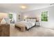 Spacious bedroom with lots of natural light, neutral decor, bench, and a comfortable seating area at 3214 Woodleaf Ct, Marietta, GA 30062