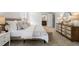 Bright bedroom featuring neutral tones, ensuite bathroom, and wooden dresser with decorative lamps at 3214 Woodleaf Ct, Marietta, GA 30062