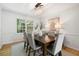 Elegant dining room with a chandelier, stylish chairs, and a large window, perfect for hosting memorable dinner parties at 3214 Woodleaf Ct, Marietta, GA 30062
