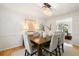 Charming dining room with a chandelier, light grey walls, and a connecting space to the living room, perfect for gatherings at 3214 Woodleaf Ct, Marietta, GA 30062