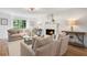 Elegant living room featuring a fireplace, large windows, and stylish furniture, perfect for relaxation and entertaining guests at 3214 Woodleaf Ct, Marietta, GA 30062