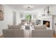 Serene living room with a cozy fireplace, natural light, and tasteful decor, creating a peaceful and welcoming ambiance at 3214 Woodleaf Ct, Marietta, GA 30062