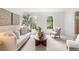 Bright and airy living room with neutral furniture, a modern plant, and lots of natural light, perfect for relaxation at 3214 Woodleaf Ct, Marietta, GA 30062