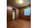 Bedroom featuring hardwood floors, wood-paneled walls, closet and a large window at 4048 Emerald Lake Dr, Decatur, GA 30035
