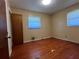 Bedroom featuring hardwood floors, neutral walls and a large window at 4048 Emerald Lake Dr, Decatur, GA 30035