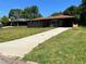 Traditional brick home with an attached carport and concrete driveway at 4048 Emerald Lake Dr, Decatur, GA 30035