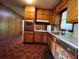 A vintage kitchen with wood cabinets, built-in oven, and tile countertops at 4048 Emerald Lake Dr, Decatur, GA 30035